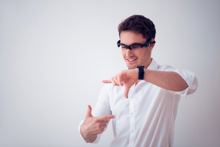 Open up new reality. Cheerful delighted handsome man using 3d glasses and evincing joy while standing isolated on white backgroundの写真素材