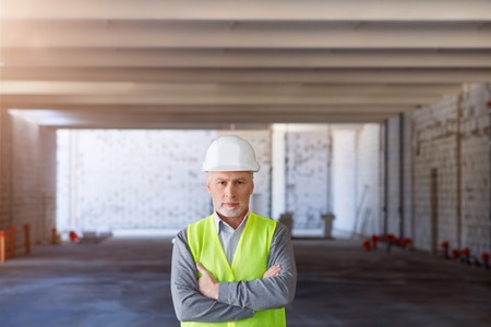 Look of decision.  Busy and angry man standing in a new building and being very confident