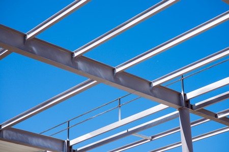 Metal construction.  A reinforcement being used in construction works standing against blue sky,...