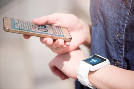 Most important. Close up of a smartphone and a smart watch used by woman