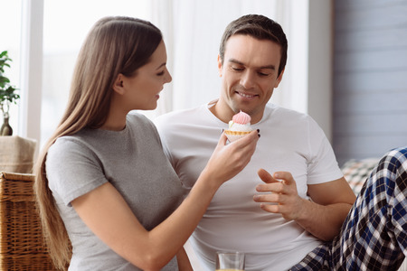 Nice caring woman holding a cupcakeの写真素材