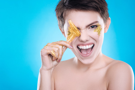 Cheerful woman having fun on blue backgroundの写真素材