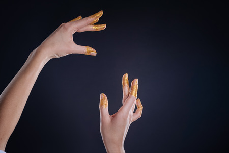 Slim hands posing on black backgroundの写真素材