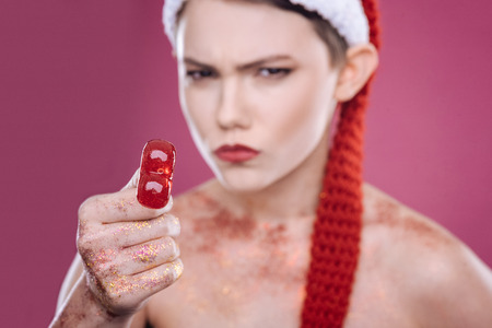 Concentrated woman holding lollipopの写真素材