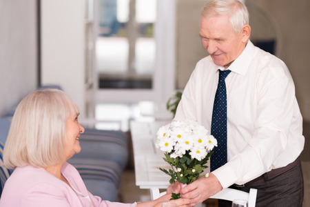 Courteous gentleman holding a bouquetの写真素材