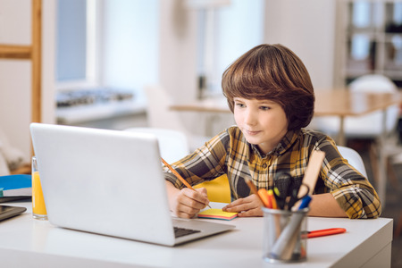 Little man-child looking at screen.の写真素材
