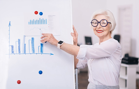 Positive aged businesswoman coaching in the officeの写真素材