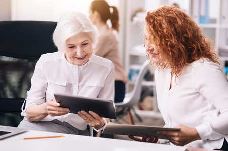 Delighted positive colleagues working in the officeの写真素材