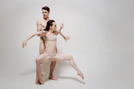 Charming creative couple performing isolated in white backgroundの写真素材