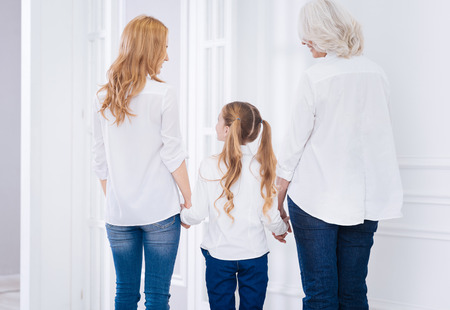 Pleasant family members holdign hands of each otherの写真素材