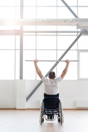 Powerful young disabled man exercising in the gymの写真素材