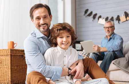 Positive pleasant man hugging his sonの写真素材