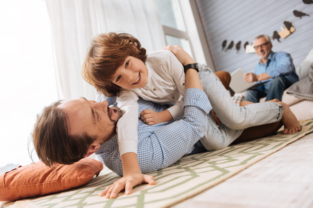 Cute happy boy spending time with his fatherの写真素材