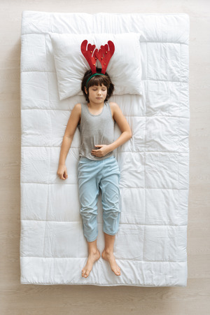 Easy goofy kid wearing unusual hatの写真素材