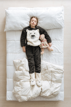 Wonderful young girl lying on the bedの写真素材