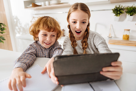 Excited funny children taking a selfieの写真素材
