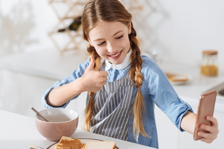 Active young lady making a picture of herself in the morningの写真素材