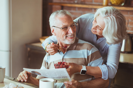 Loving aged couple enjoying their breakfastの写真素材