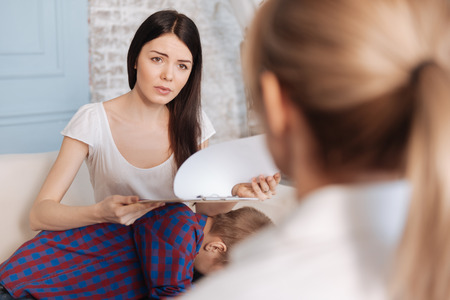 Curious female looking on her psychologistの写真素材