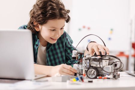 Charming teen boy studying in the science studioの写真素材