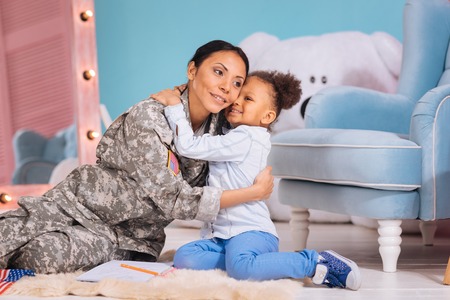 Sweet emotional child appreciating her moms assistanceの写真素材