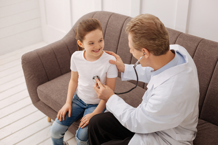 Adorable little patient not afraid of the doctorの写真素材