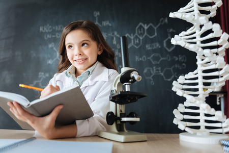 Inspired little researcher studying science in the laboratoryの写真素材