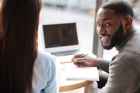 Young bearded guy holding his notebookの写真素材