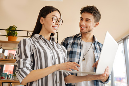 Business partners checking information on laptopの写真素材