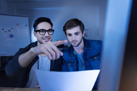 Nice delighted hacker entering a secret passwordの写真素材