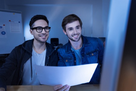 Cheerful smart hackers committing a cyber crimeの写真素材