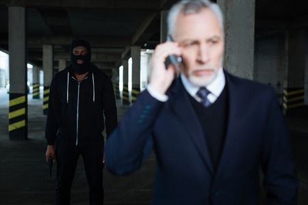 Serious male kidnapper wearing a maskの写真素材