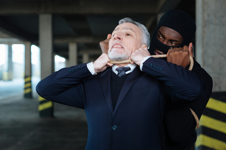 Dangerous cruel criminal holding the ropeの写真素材