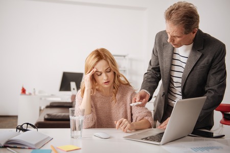 Concerned businessman offering help to ill coworker in the officeの写真素材