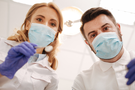 Precise competent dentists making their patients smile beautifulの写真素材