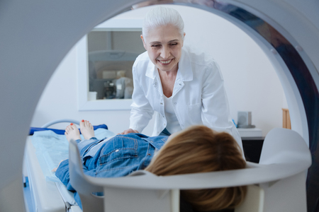 Delighted aged doctor smilingの写真素材