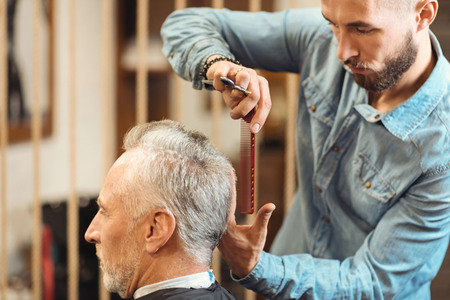 Young master creating new haircut in the salonの写真素材
