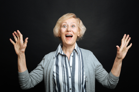 Amused aging woman expressing emotions in the studioの写真素材