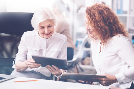 Attentive blonde bowing her head before the tabletの写真素材