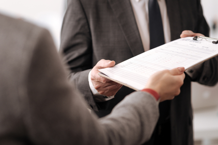 Close up of folder with documents being in male hands