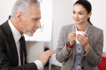 Attractive office worker listening to her coworkerの写真素材