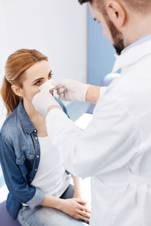 Professional experienced doctor looking at his patientの写真素材