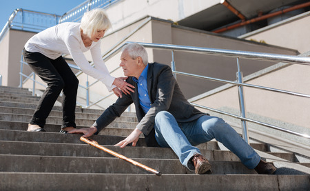Retired pensioner resting on the stairs on the promenadeの写真素材