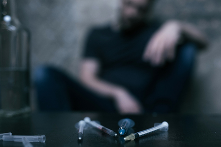 Infected syringes lying on the table in the darknessの写真素材