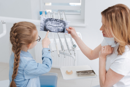 Lovely patient and the dentist examining xray togetherの写真素材