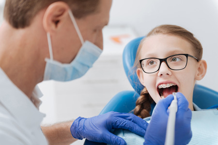 Trained wise dentist employing modern equipment