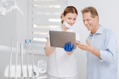 Competent young dentist happy with resultsの写真素材