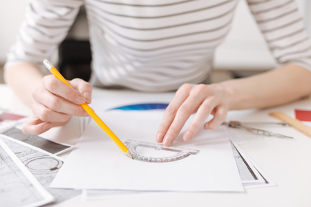 Skillful female engineer using a protractorの写真素材