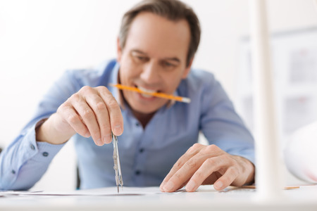 Professional involved engineer drawing a blueprint