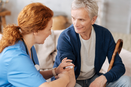 Competent neat doctor applying vaccineの写真素材